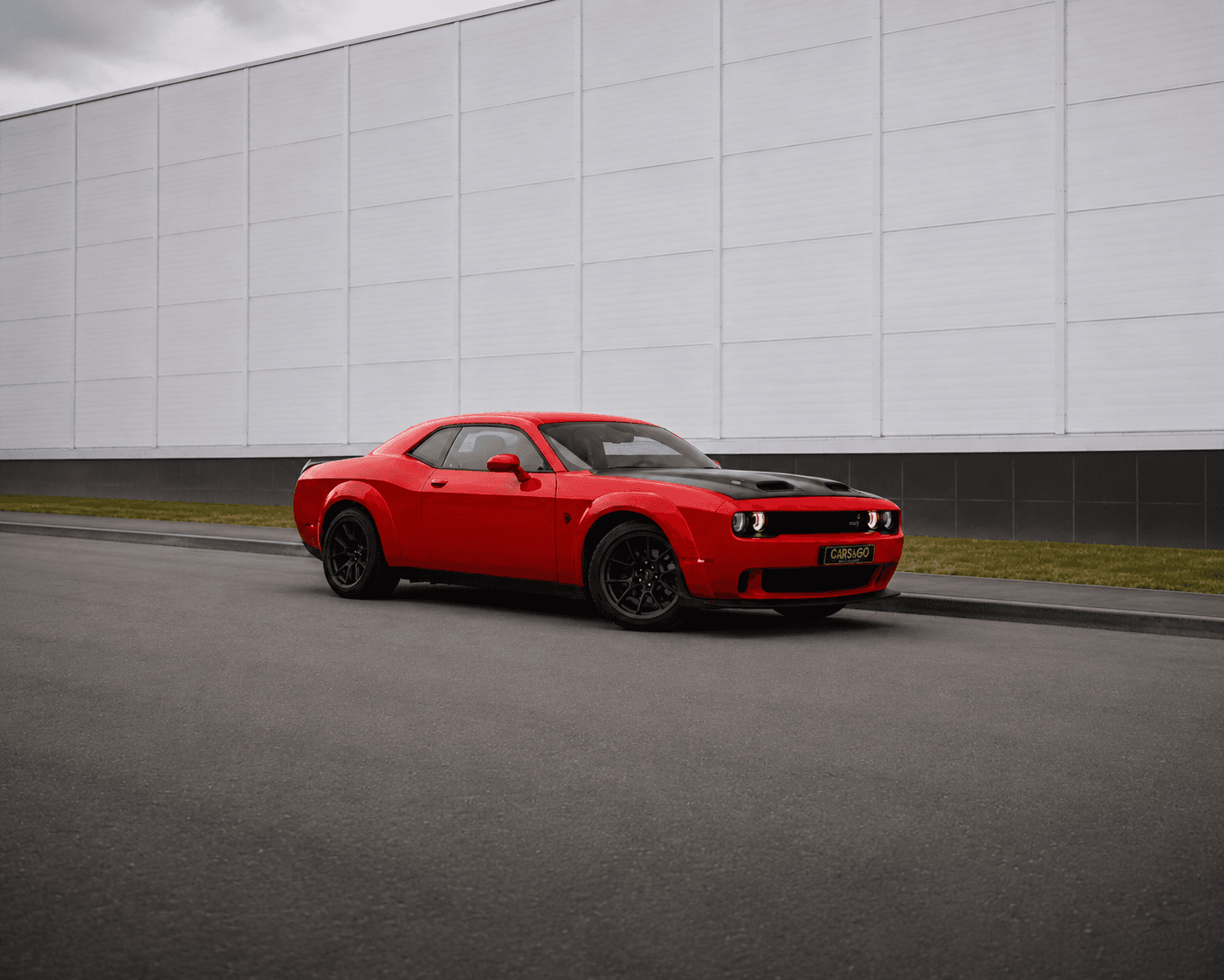 wide_outdoor_automotive_scene_a_red_muscle_car_d